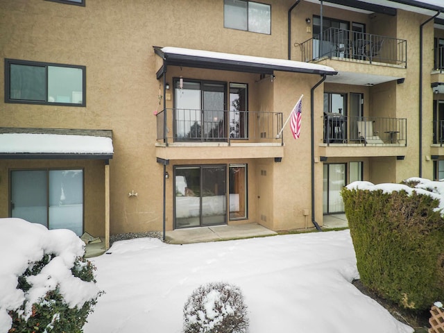 view of snow covered rear of property