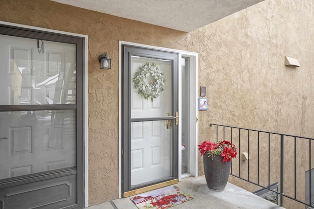 property entrance featuring stucco siding