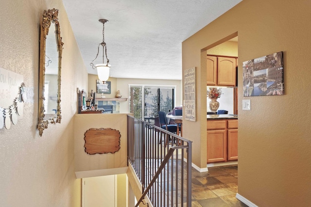 5107N Argonne Ln # 4, Spokane, WA 99212 - hall featuring baseboards, an upstairs landing, a textured wall, and a textured ceiling