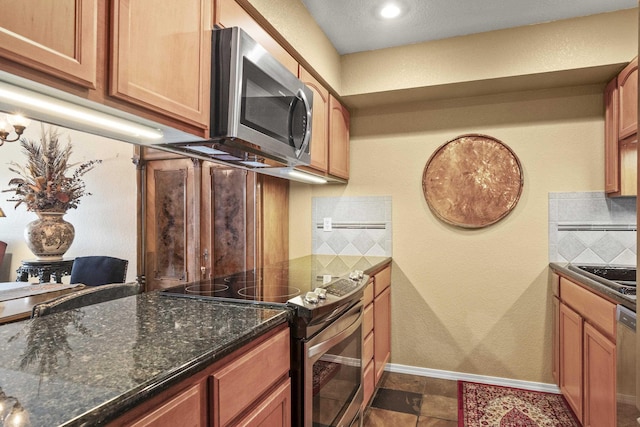5107N Argonne Ln # 4, Spokane, WA 99212 - kitchen featuring decorative backsplash, baseboards, dark stone counters, appliances with stainless steel finishes, and a sink