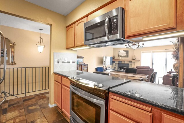 5107N Argonne Ln # 4, Spokane, WA 99212 - kitchen with open floor plan, backsplash, appliances with stainless steel finishes, stone finish flooring, and a fireplace
