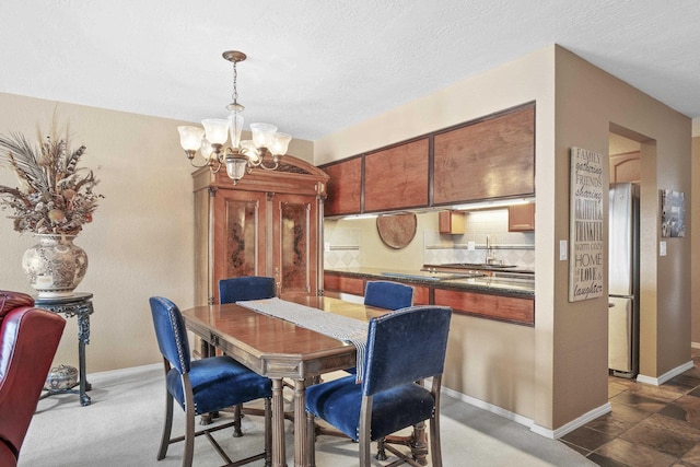 5107N Argonne Ln # 4, Spokane, WA 99212 - dining space with baseboards, a textured ceiling, and a chandelier