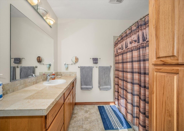 bathroom with tile patterned flooring and vanity