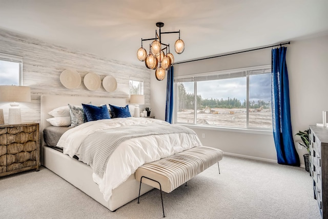 carpeted bedroom with an inviting chandelier