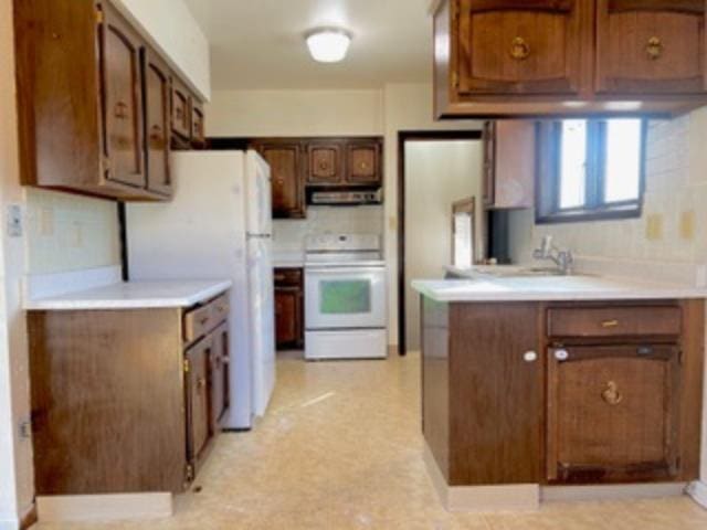 kitchen featuring sink and white appliances