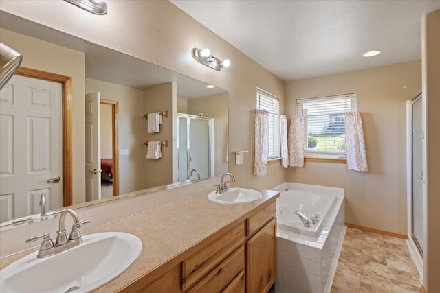 bathroom featuring separate shower and tub and vanity