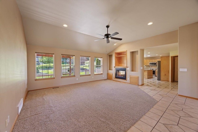 unfurnished living room with ceiling fan, a multi sided fireplace, light colored carpet, and lofted ceiling