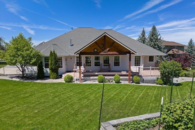 back of house featuring a yard and a wooden deck