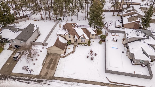 snowy aerial view featuring a residential view