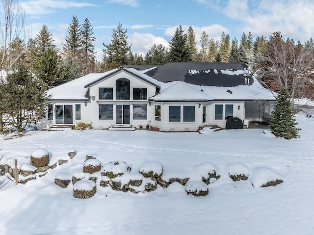 view of snow covered rear of property