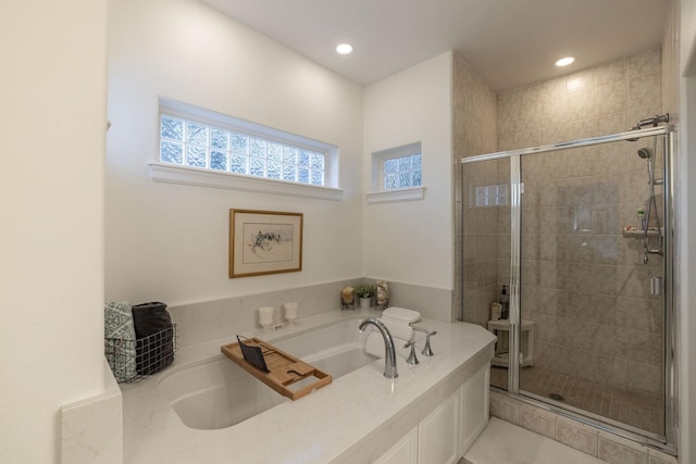 bathroom featuring independent shower and bath