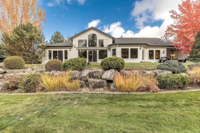 rear view of property with a lawn