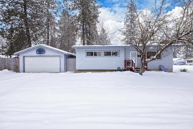 view of front of home with a garage and an outdoor structure