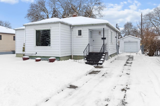 view of front of property featuring an outdoor structure and a garage