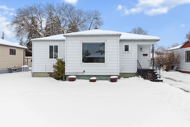 view of snow covered rear of property