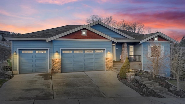 craftsman house featuring concrete driveway, stone siding, and a garage