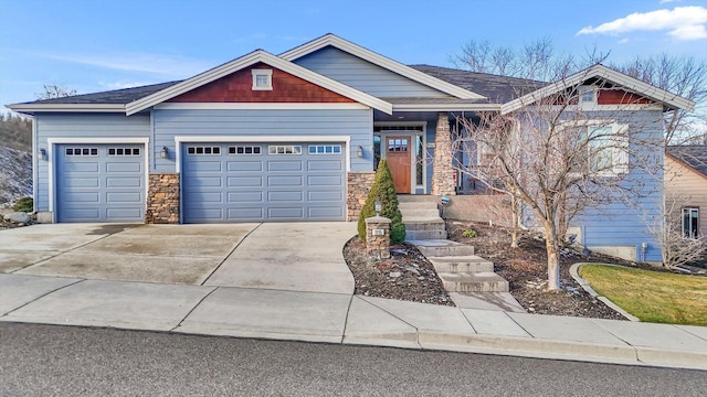 craftsman house featuring an attached garage and concrete driveway