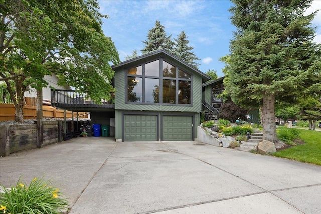 view of property exterior with stairway, driveway, and a garage