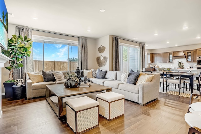 living room with light wood-style floors and recessed lighting