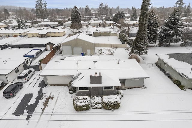 snowy aerial view featuring a residential view