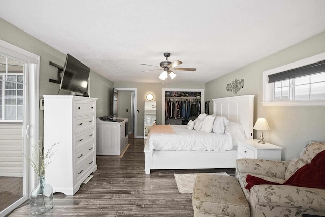 bedroom with a closet, dark wood-style flooring, and a ceiling fan