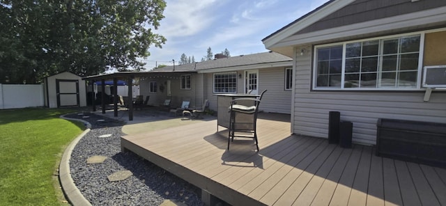 deck featuring a yard, an outdoor structure, a storage shed, and fence