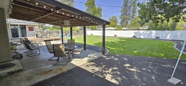 view of patio with a fenced backyard and outdoor dining space