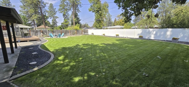 view of yard featuring a fenced backyard and a wooden deck