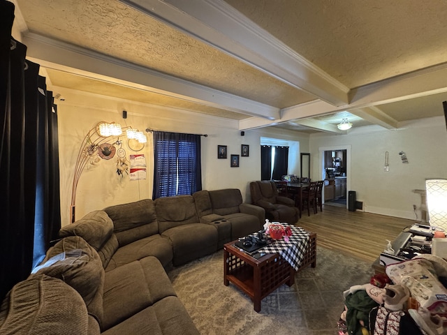 living area with dark wood-style floors, crown molding, baseboards, and beamed ceiling