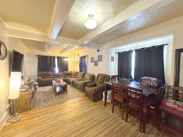 living area featuring coffered ceiling, wood finished floors, and beamed ceiling