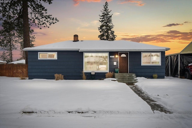 single story home featuring fence and a chimney