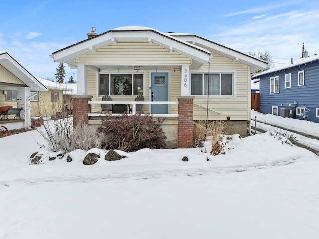 view of front of home with covered porch and central AC unit