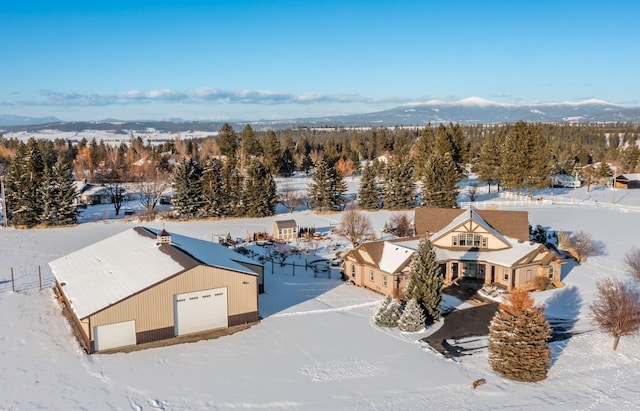 snowy aerial view with a mountain view