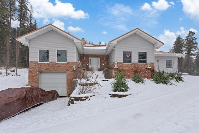 ranch-style home with a garage and brick siding