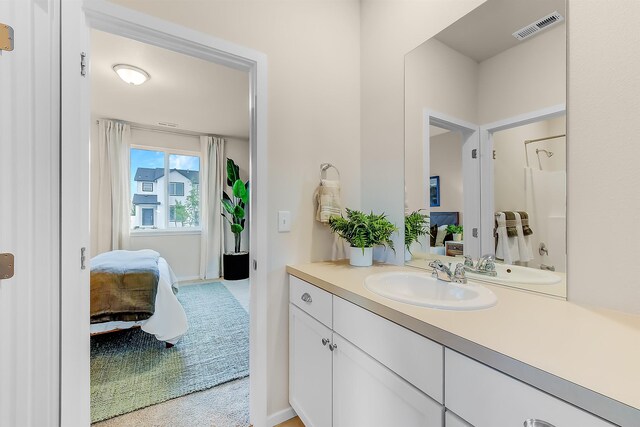 ensuite bathroom with vanity, visible vents, and ensuite bathroom