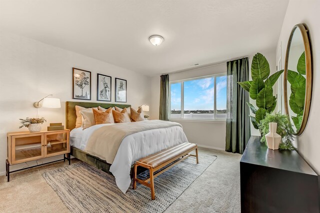 bedroom with baseboards and light colored carpet