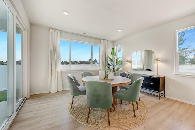 dining space with baseboards, recessed lighting, and light wood-style floors