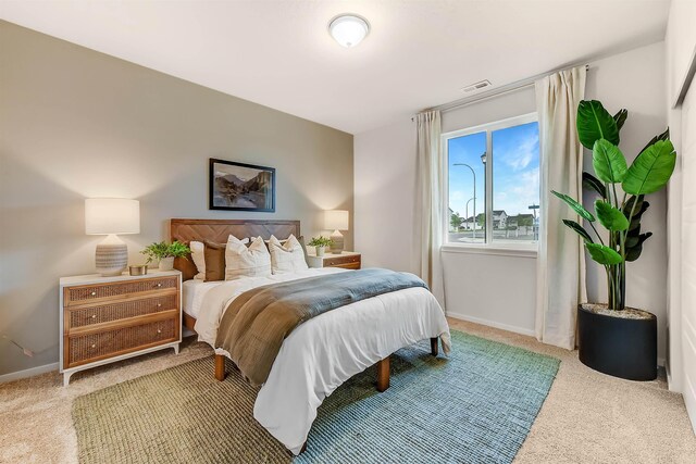 carpeted bedroom featuring baseboards