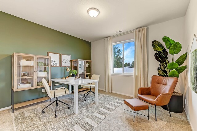 office space with visible vents, light colored carpet, and baseboards