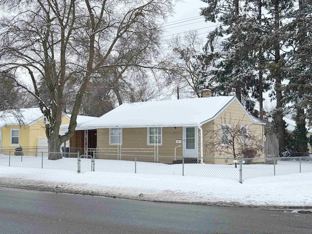 view of front of home with a chimney and fence