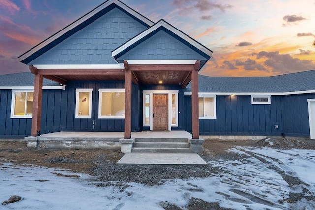 view of front of house with board and batten siding and roof with shingles