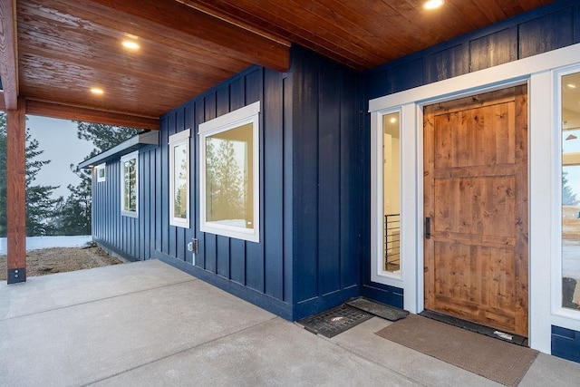 property entrance featuring board and batten siding