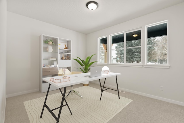 carpeted office featuring baseboards