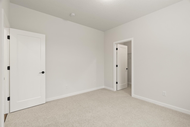 empty room with baseboards and carpet floors