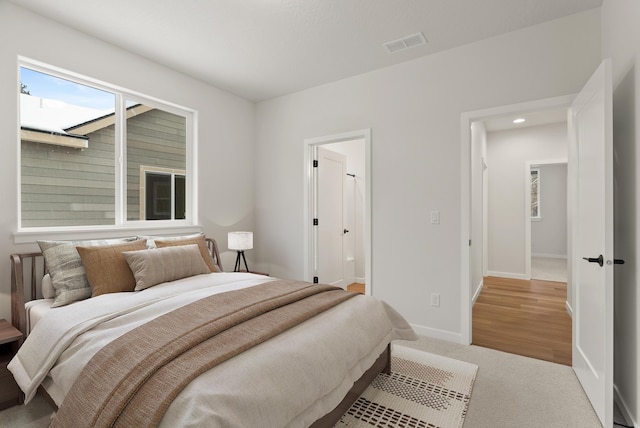 bedroom featuring carpet flooring, baseboards, and visible vents