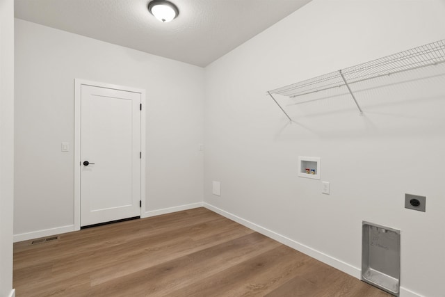 washroom featuring hookup for a washing machine, visible vents, light wood finished floors, hookup for an electric dryer, and laundry area