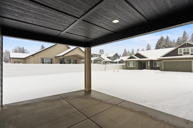 snow covered patio with fence