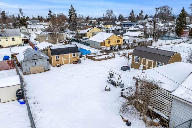 snowy aerial view with a residential view