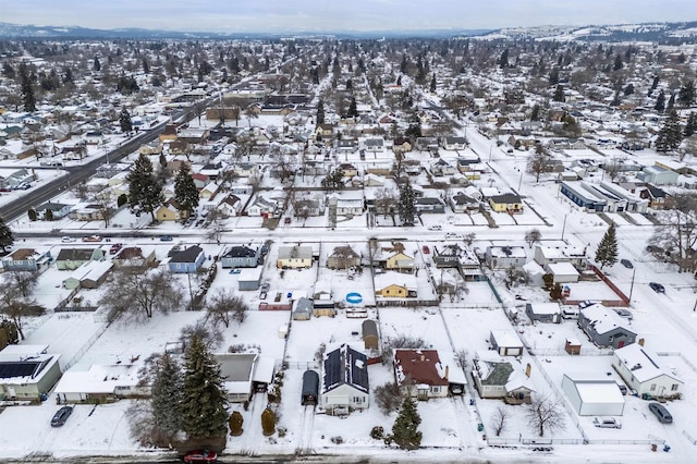 snowy aerial view featuring a residential view