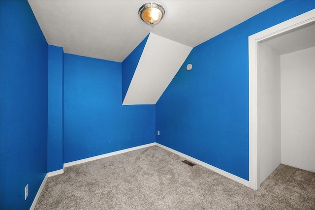 bonus room with vaulted ceiling, carpet, visible vents, and baseboards